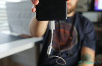 Ein Mann, der ein Telefon mit einem Google-Dongle anstelle von USB-C-Kopfhörern hält.